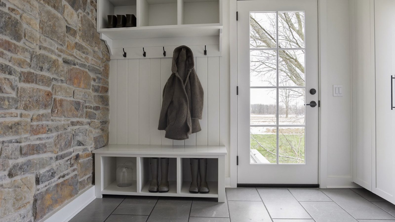 Tiled mudroom floor by a back door in a Chester County farmhouse