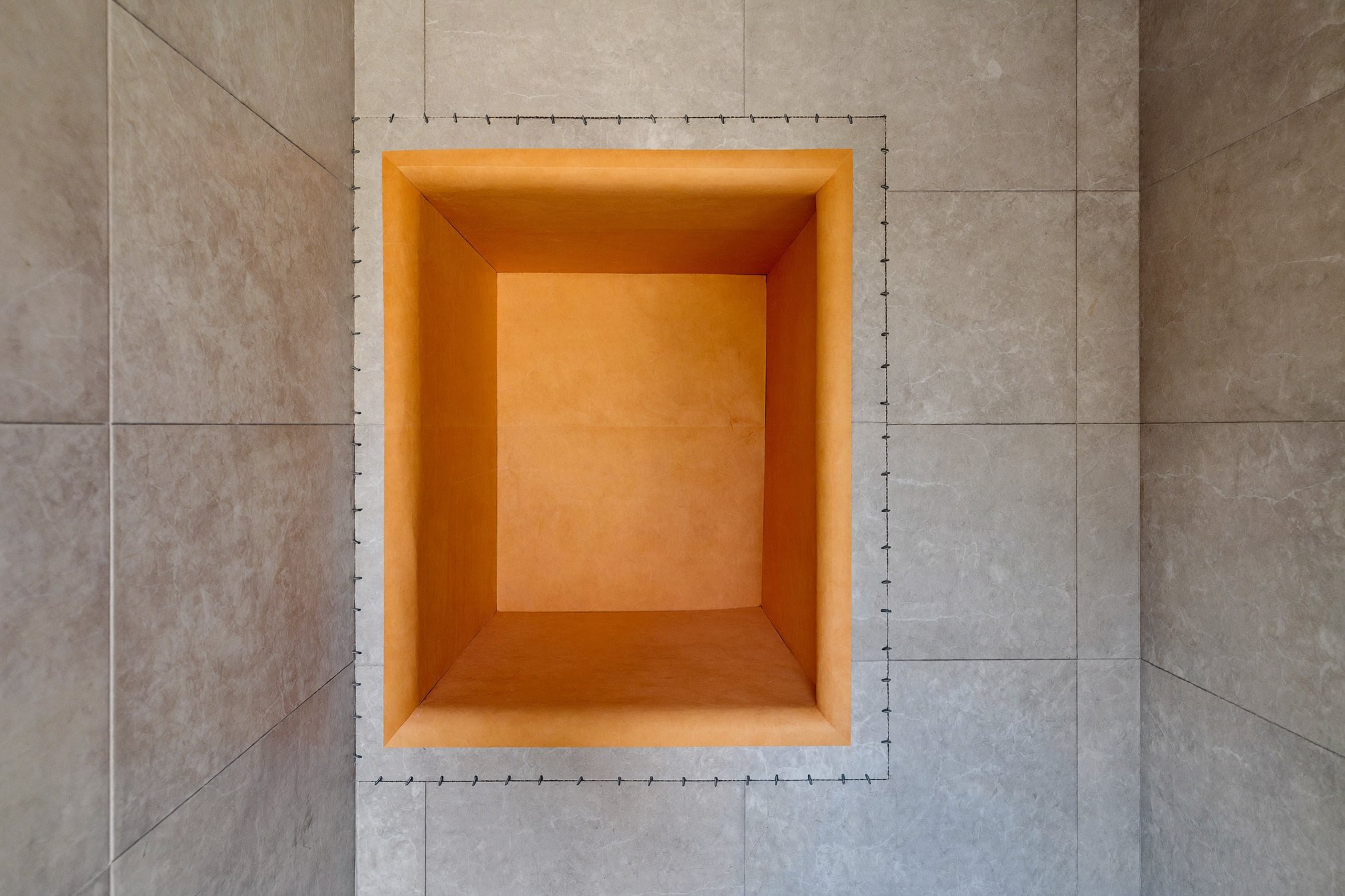Close-up of a waterproofed shower niche corner ready for tile
